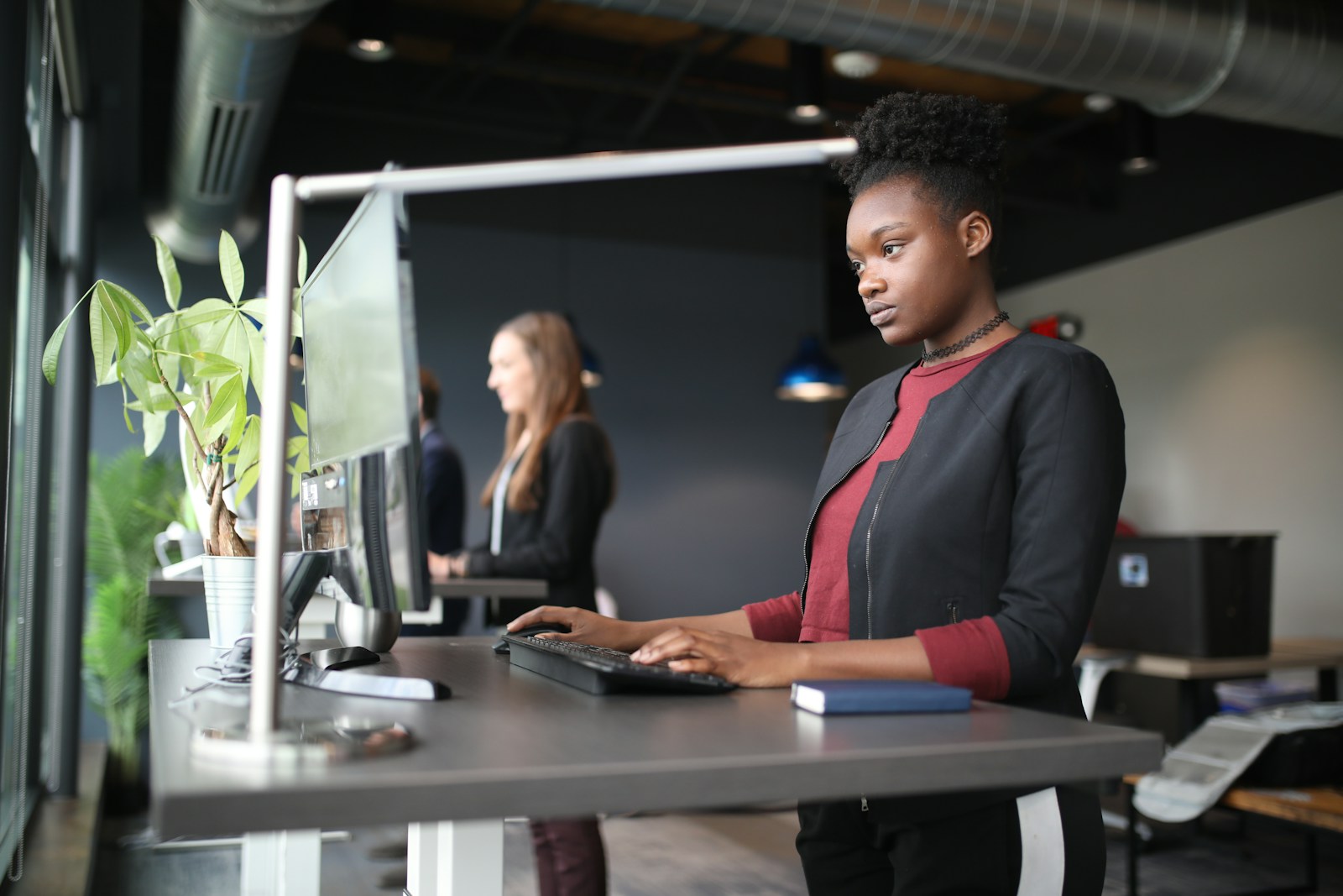 A person working at an adjustable standing desk