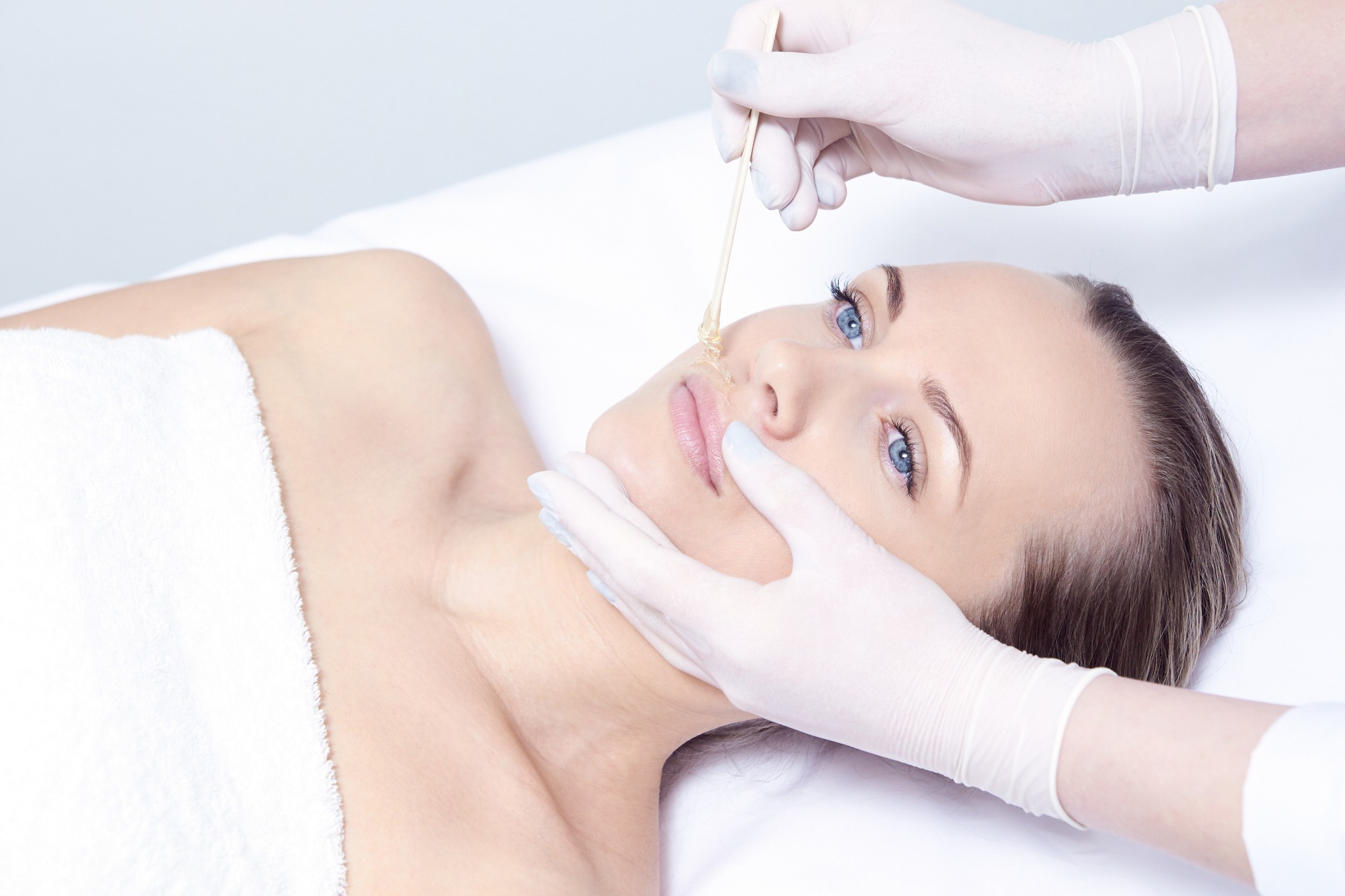 Professional facial waxing treatment focusing on the upper lip